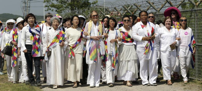International women activists including Gloria Steinem and two Nobel Peace laureates on Sunday were denied an attempt to walk across the Demilitarized Zone dividing North and South Korea, but were allowed to cross by bus and complete what one of them called a landmark peace event. (AP Photo/Lee Jin-man)